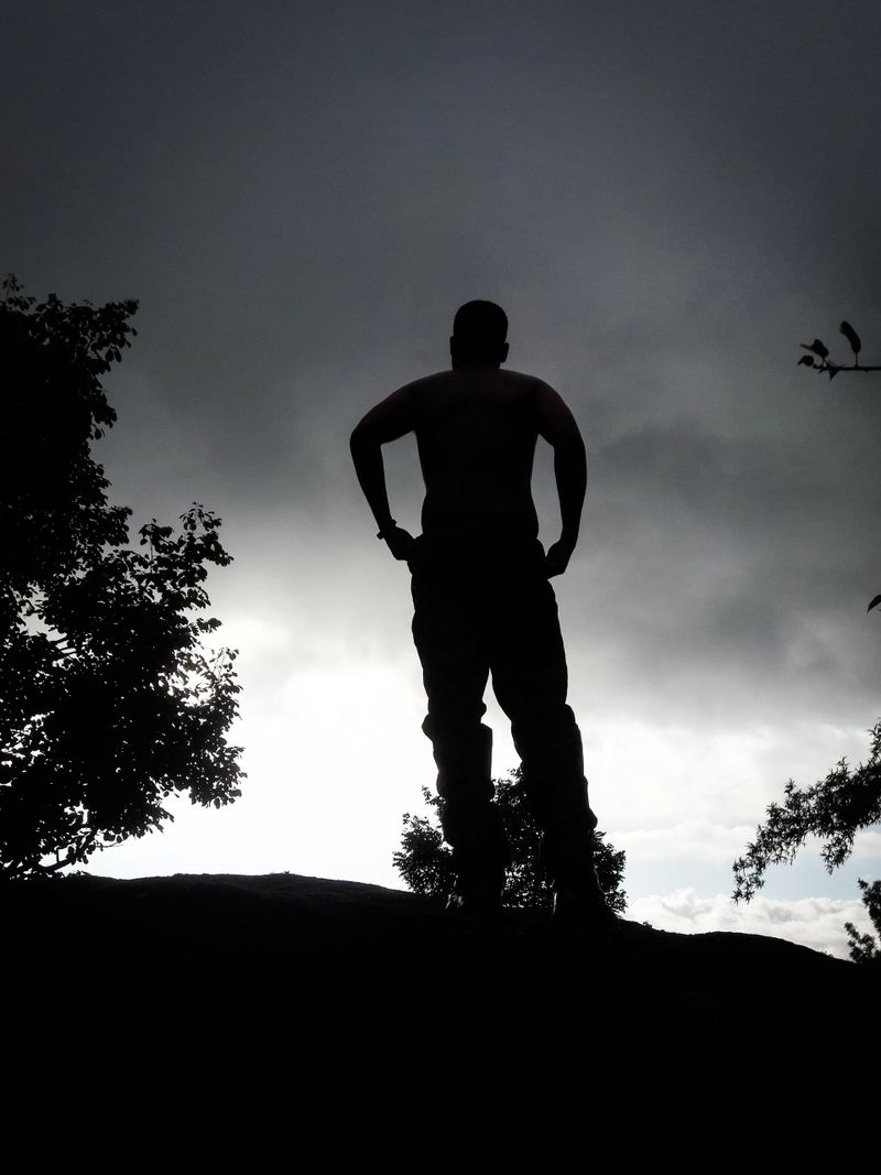 boy back light shot in deep green forests feeling the true nature image is taken at south india. it is showing the serene nature of south india.