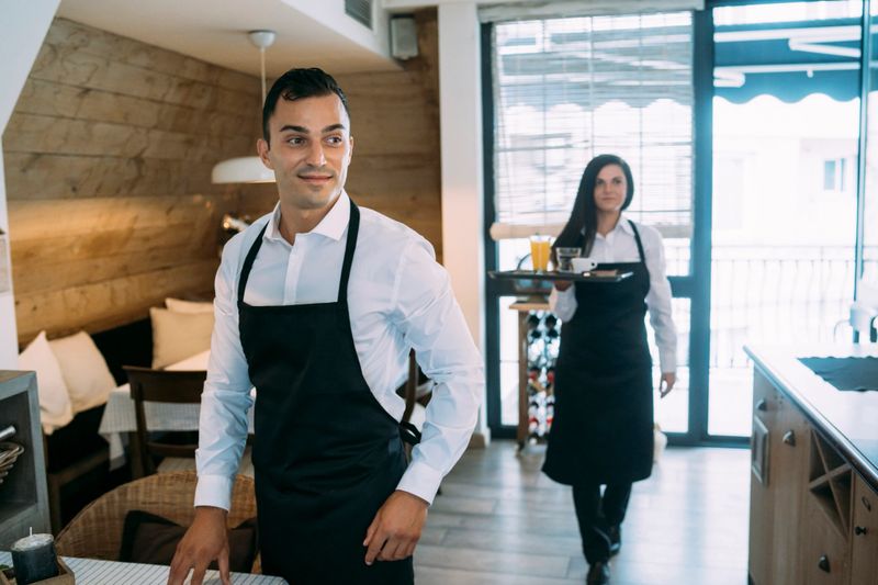 Young waiters during their work in a restaurant