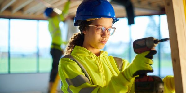 Woman worker using a power drill.