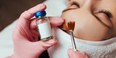 Applying a skincare solution to a woman's face.