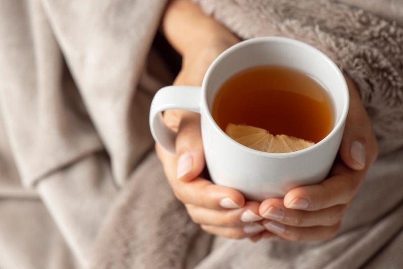 Woman holding a cup of tea.