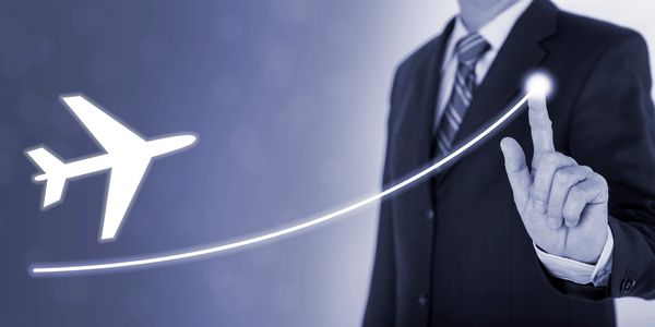 A person in a suit showing a vision for an aircraft to follow with his finger