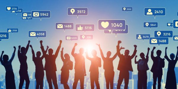 Silhouetted group celebrating with social media notification icons above.