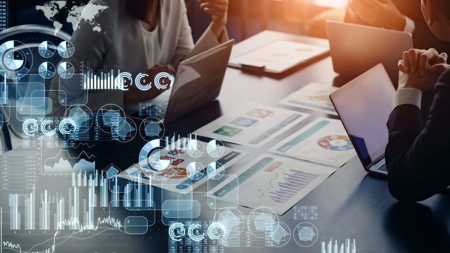 Business team analyzing data and charts with digital overlays in a meeting.