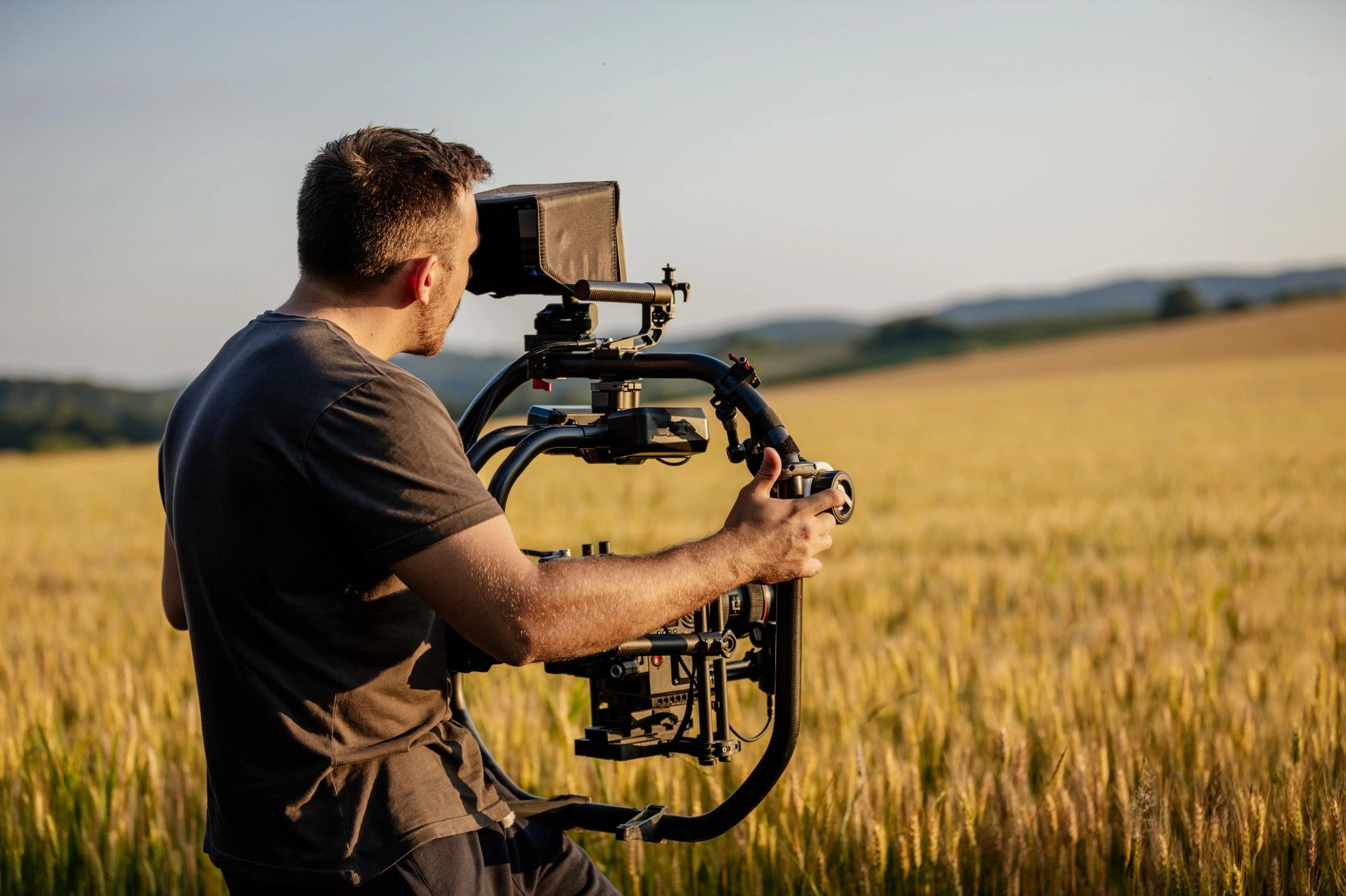 director of photographer using a DJI ronin gimbal in a sunny field