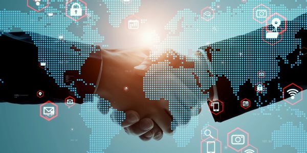 Handshake over digital world map with technology icons.
