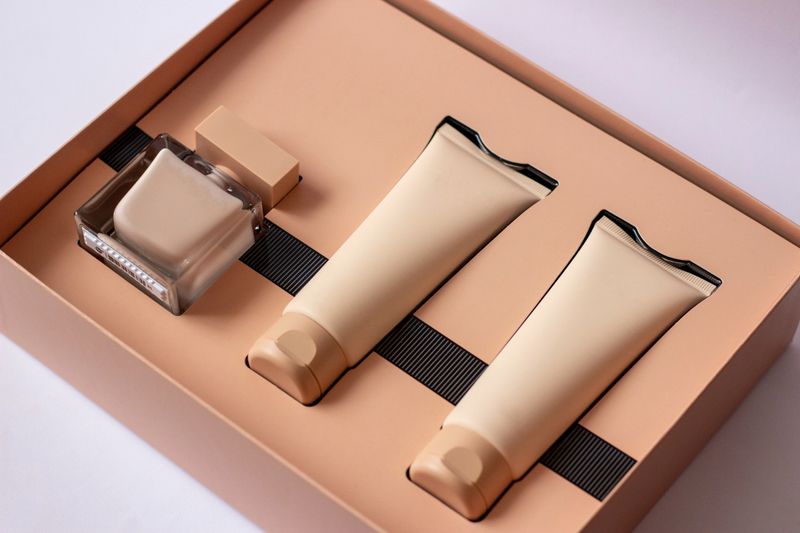 Close-up of a set of perfumed water, cream-colored shower gel in a gift box . Close-up photo on a white background.