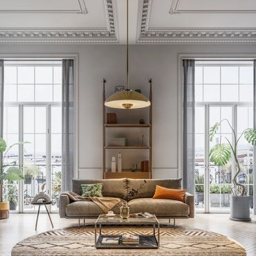 Elegant living room with a cozy sofa and large windows letting in natural light.