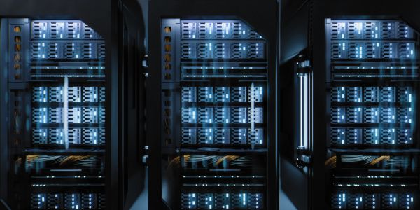 Interior view of three server racks with blue lights.