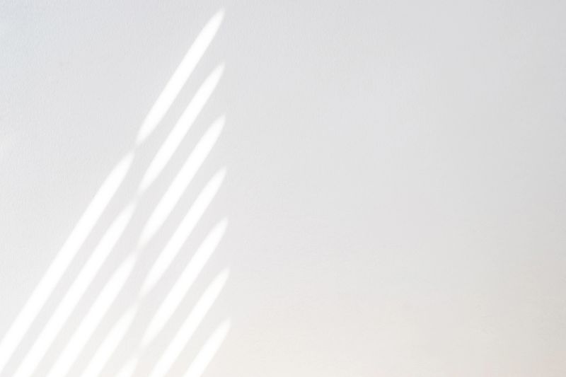 Architectural shadows. Sunlight architecture abstract background with light, black shadow overlay from window on white texture wall. Mockups, posters, stationary, wall art, design presentation