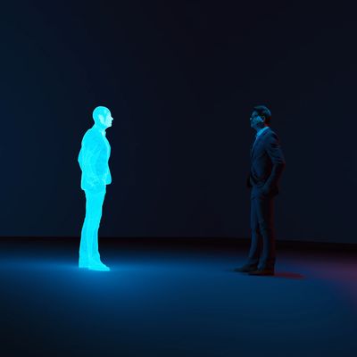 A man faces a glowing blue hologram of himself in a dark room.