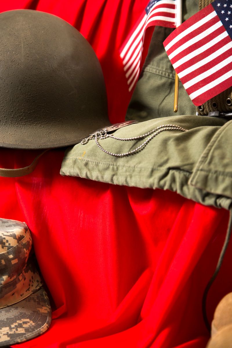 US Military Display.  Gear from past US wars.WWII battle helmet, Vietnam field jacket, Korean War pistol belt.  Small American Flags.IT IS THE SOLDIER THAT GIVES US OUR FREEDOMES, WHO DEFENDS THE CONSTITUTION AND IS WILLING TO GIVE THEIR LIFE FOR THOSE FREEDOMS. THANK A SOLDIER.