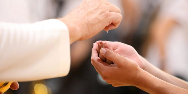 A person receiving a drop of liquid on their hands.