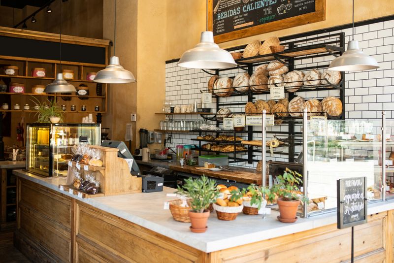 Interior of a local coffee shop. Bakery counter with freshly baked food displayed for selling.