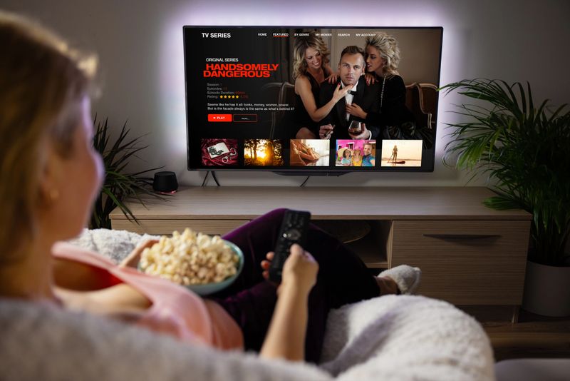 Female watching TV series and movies via streaming service at home