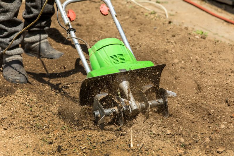Gardening. Spring work on the farm. Land cultivation with an electric cultivator. Man plows the earth with an electric cultivator.