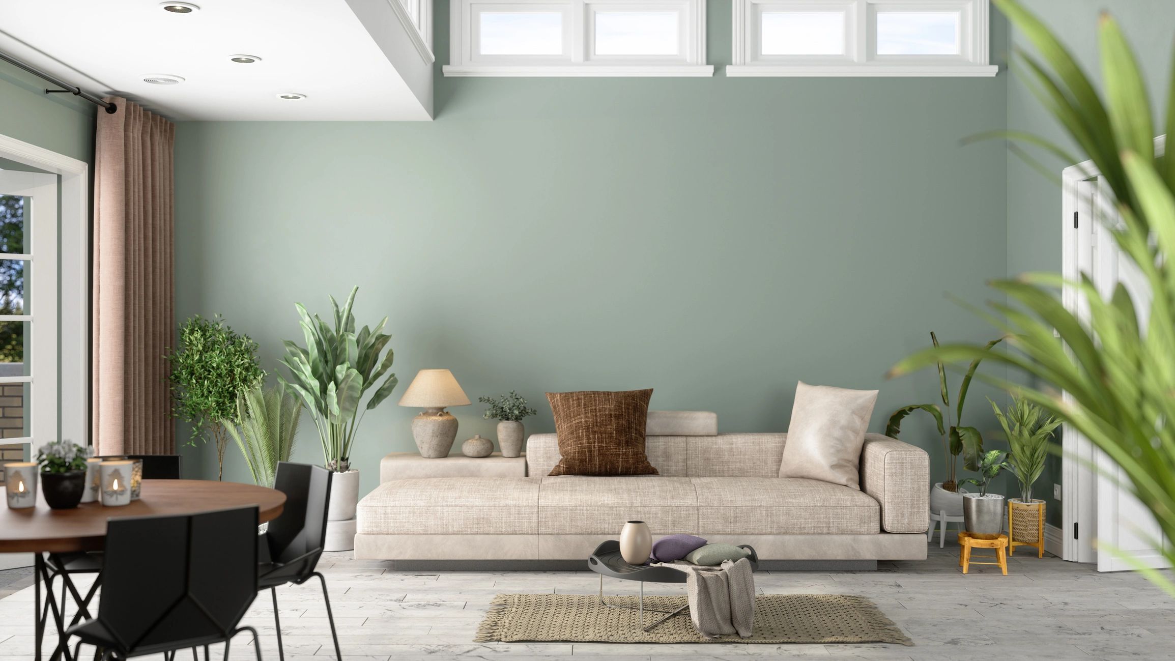Light-filled living room with soft green walls, neutral furnishings, natural wood and greenery.