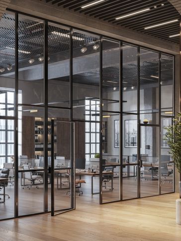 Modern office space with glass walls and wooden floors.