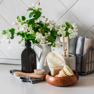 A bathroom countertop with spa accessories and white flowers.