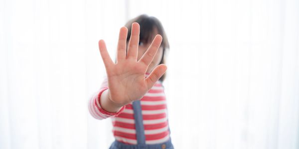 Child holding up hand to indicate prohibited items for Cola Kids Consignment