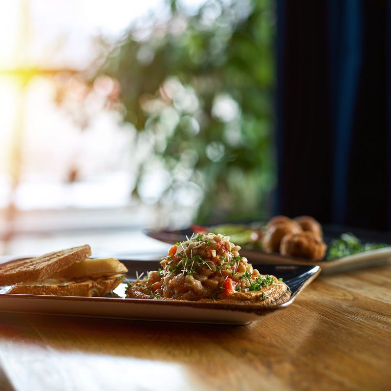 classic oriental appetizer dish - chickpea hummus with white olive oil and vegetable salsa. Restaurant food, Traditional arabic food