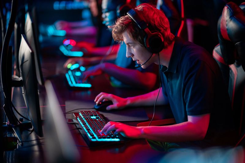 Professional esports players at an online game tournament. The cyber team plays computers and trains.
