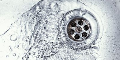 Water flowing down a sink drain.