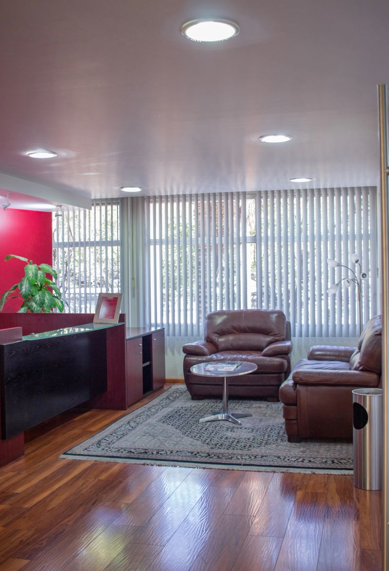 Office waiting room, with armchairs and magazines.