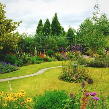 A vibrant garden with colorful flowers and a winding path.