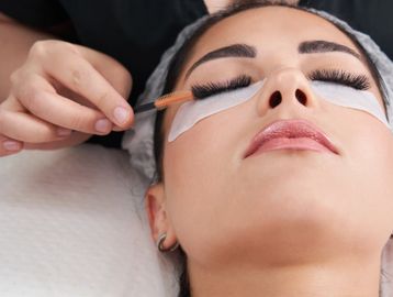 Woman receiving gorgeous mega volume eyelash extensions in Everett, WA at Autumn Noel Esthetics.