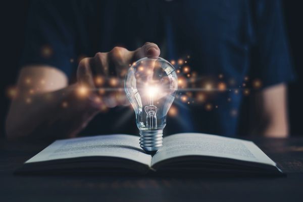 Lightbulb over open book representing good reviews