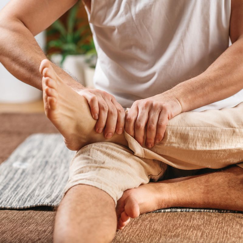 Foot and leg relaxing Thai massage. Thai massage uses pressure along the energy lines lowering stress and relieving muscular tension.