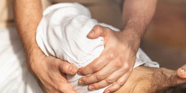 A person receiving a shoulder massage.