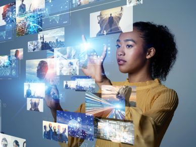 Woman interacting with virtual digital screens.