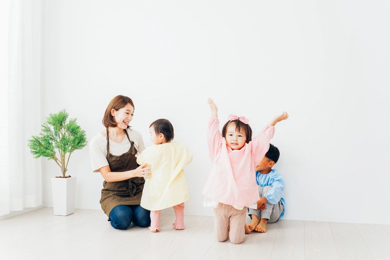Children playing at the kindergarten with nursery teachers