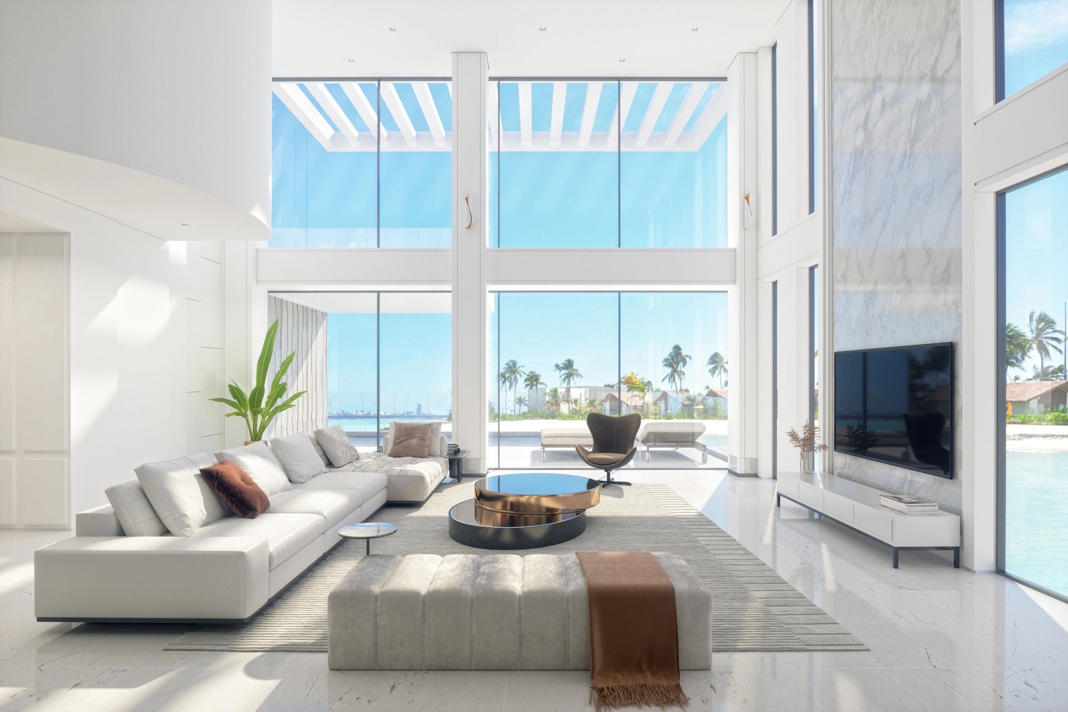 Bright modern living room with large windows and ocean view.
