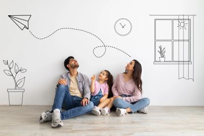 Family watching a paper airplane on a wall drawing.
