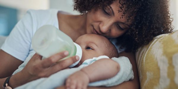 Baby bottle feeding milk formula or breastmilk