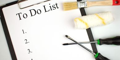 Clipboard with blank to-do list and painting tools nearby.