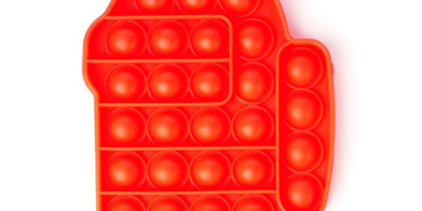 Red silicone pop-it toy in the shape of a hand.