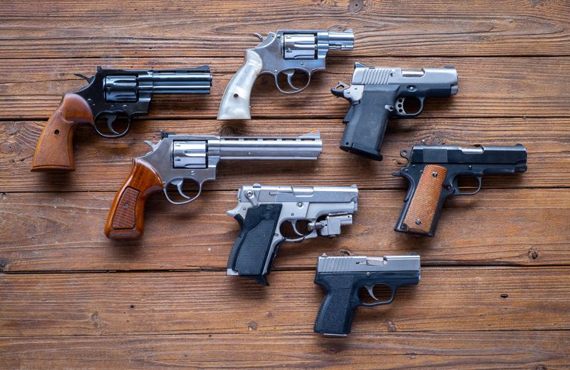 Seven handguns, some revolvers, some semi-automatic, in different calibers.