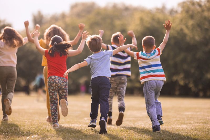 Happy child playing in a colorful park during a sunny photoshoot