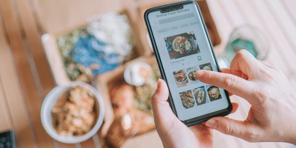 Person ordering food delivery on smartphone.