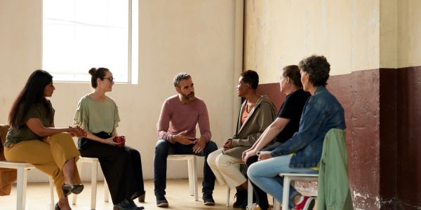 Group therapy session with diverse participants.