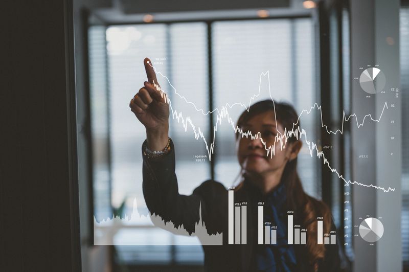 An Asian businesswoman plan growth and increase of positive indicators in her business. Business growth concept year 2021.