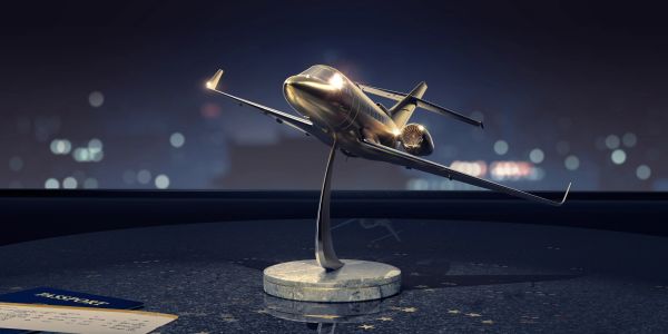 Shiny airplane model on a stand with a ticket.