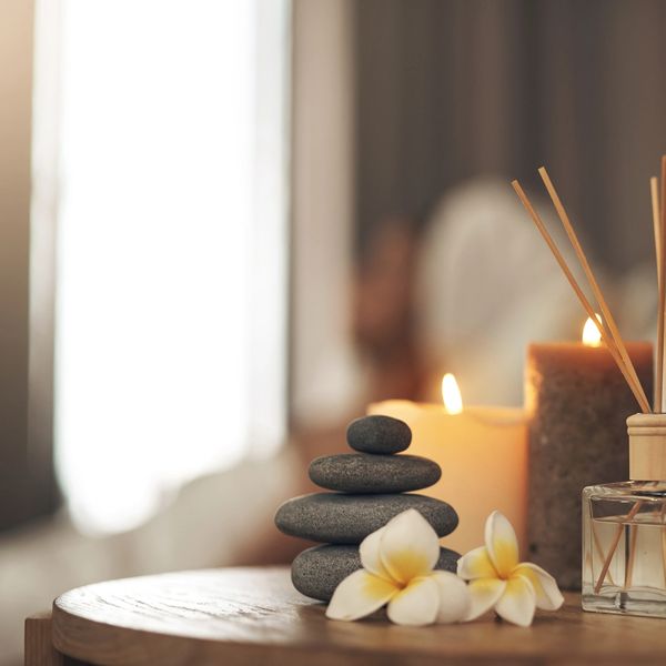 Stacked spa stones, candles, and flowers create a calming ambiance.