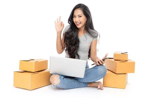 Woman starting an online drop shipping business from home with a laptop computer.