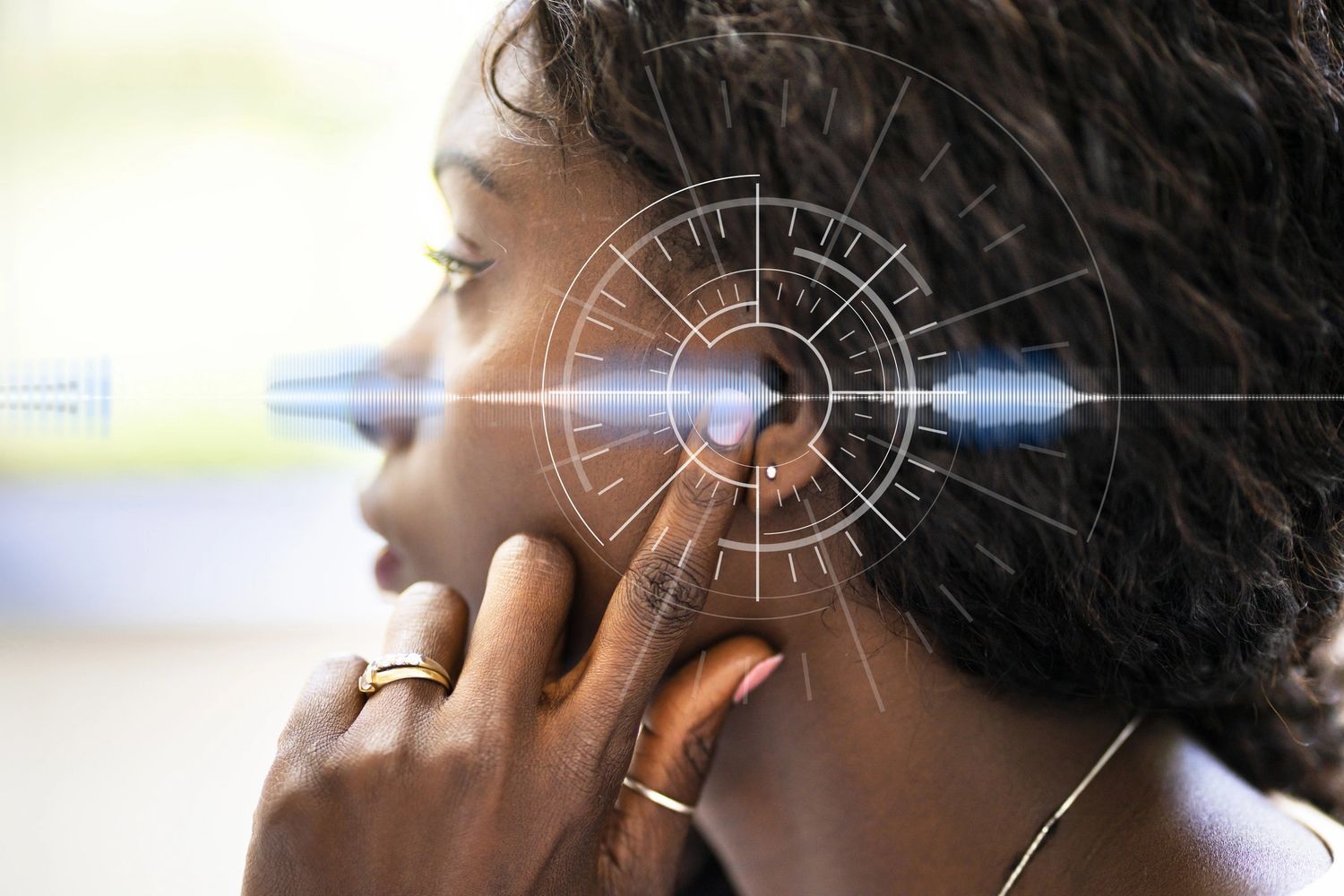 Woman adjusting wireless earbud with digital soundwave overlay.