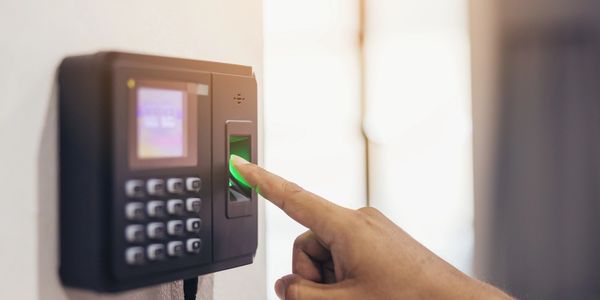A person using a fingerprint scanner for access control.